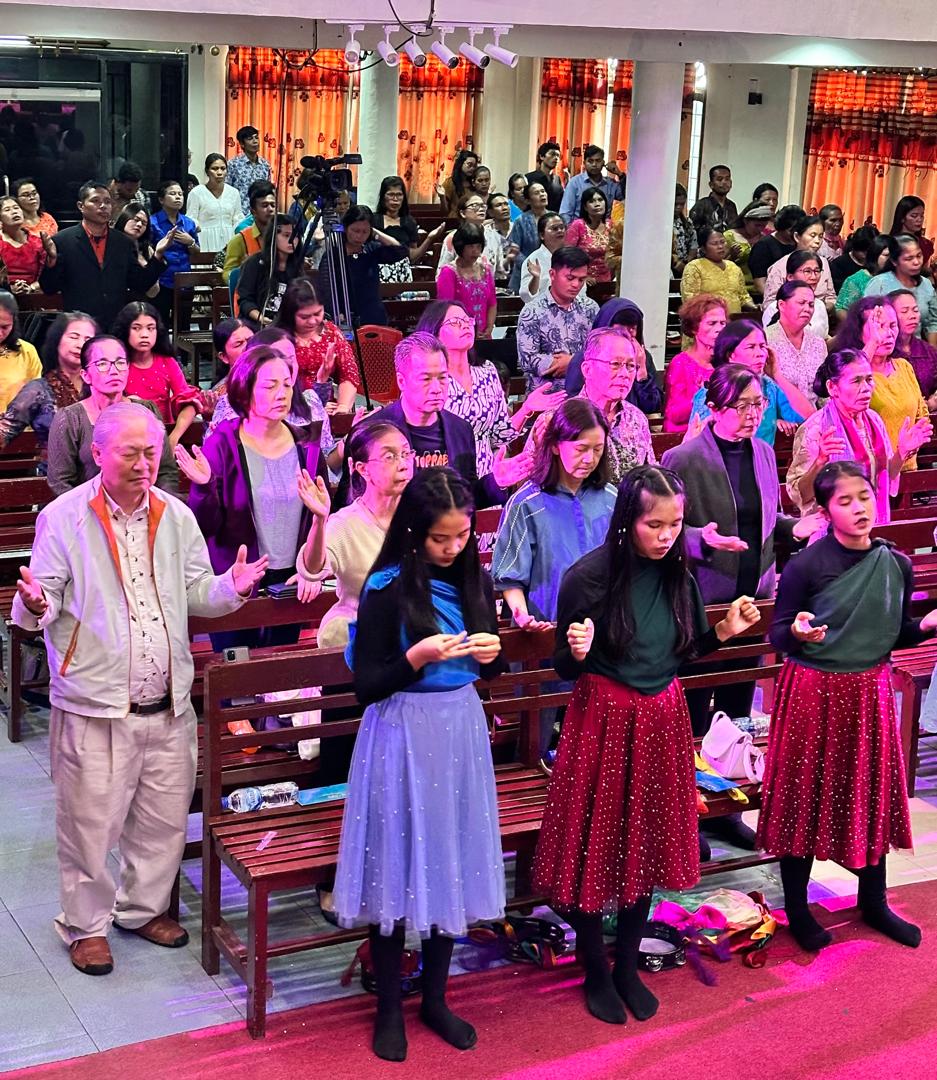 A congregation gathering in worship and prayer